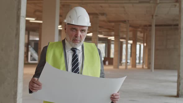 Bearded Construction Supervisor Posing with Paper