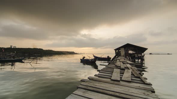 Timelapse beautiful sunrise with sun ray at fisherman wooden hut.
