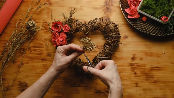 Woman Decorating Valentines Day Floral Wreath