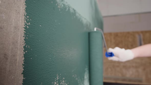 Renovation Painting Walls with Blue Paint Using Brush Closeup