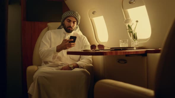 Millionaire Talking Cell Phone in Airplane