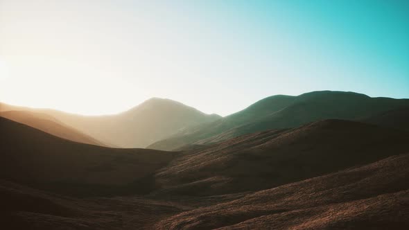 Hills with Rocks at Sunset