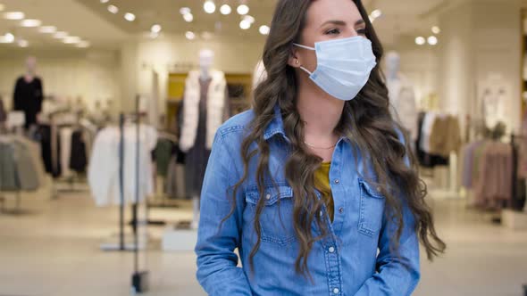 Video of happy woman in shopping mall during pandemic. Shot with RED helium camera in 8K.