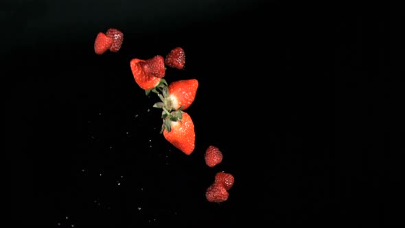 Red fruits being throw in super slow motion