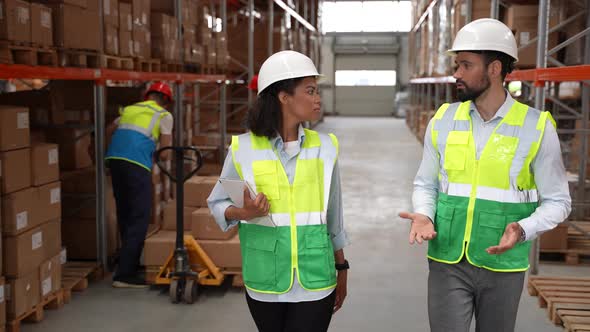 Logistics Managers Walking Through Warehouse