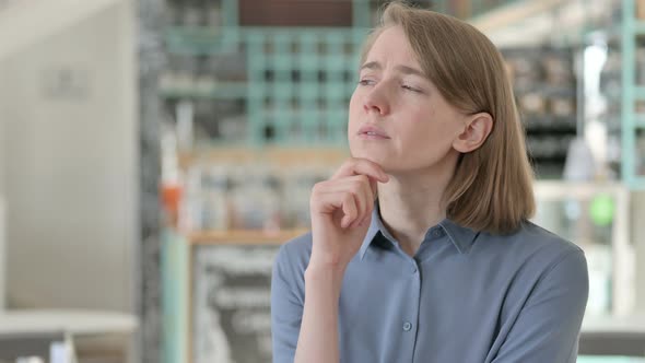 Portrait of Young Woman Sitting and Thinking