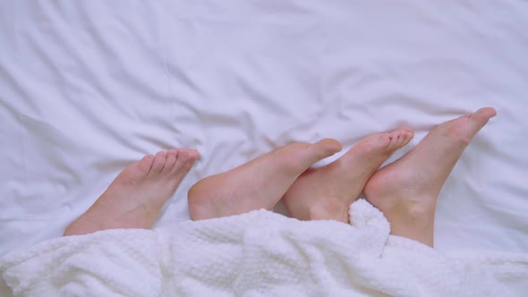 Close Up Pair Sleep Woman and Man Feet in Bedroom