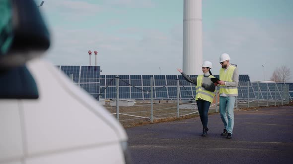 Ecological Engineers Walk at the Solar Panel Field Shot From Far