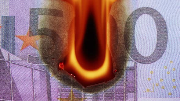 Burning of 500 Euro Banknote on Black Bacground Closeup