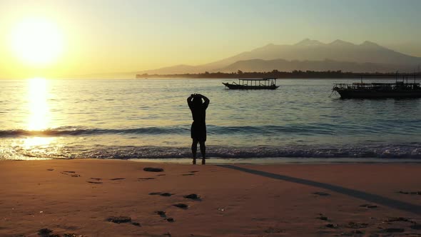 Tourist suntans on beautiful island beach lifestyle by turquoise lagoon with white sandy background 