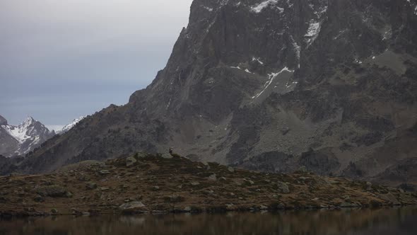 Pic du Midi d'Ossau, Lac d' Ayous (French Pyrenees). Man walking through the mountains with huge bac