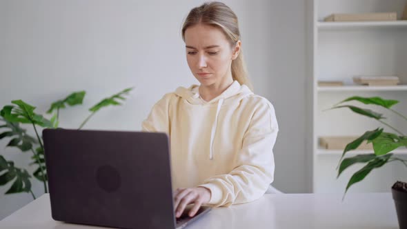 Worker Typing on Laptop at Workplace