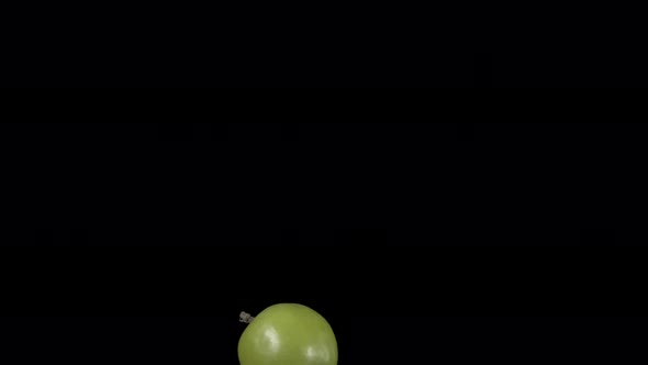Flying Green Apple on a Black Background