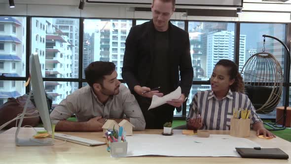 Creative Business People Group Having Conversation at Office Desk in Workplace