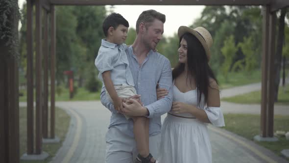 Positive Friendly Interracial Family Walking Summer Park Talking