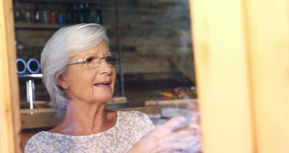 Senior woman interacting in cafe 4k