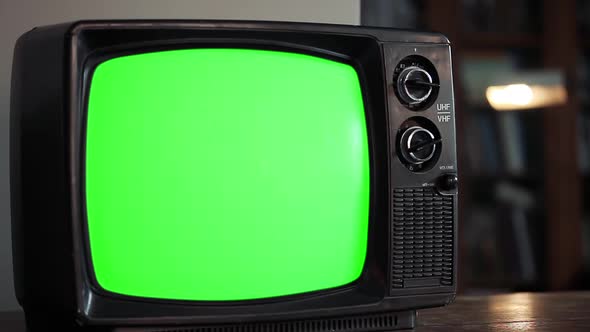 Male Hand tuning an Old Television Green Screen.