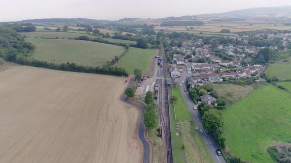 Wide aerial shot tracking forward over the vast somerset landscape, and the village of Washford, imm