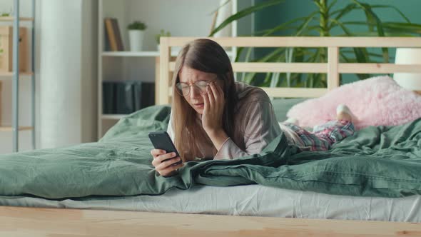 Stressed Nervous Young Woman Looking at Cellphone Screen Feeling Frustrated