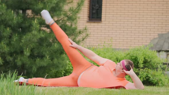 Fat man engaged in fitness outdoors