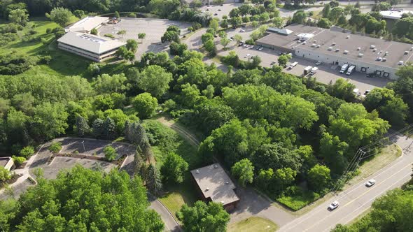 Aerial view over Hopkins, Minnesota, business district with lots of woodlands and parking lots.