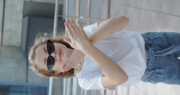 Close View of Little Girl in Stylish Look and Glasses Dancing on Urban Area