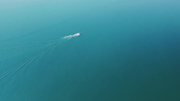 Aerial View of White Yachts Sailing in Still Calm Blue Teal Waters Michigan Lake