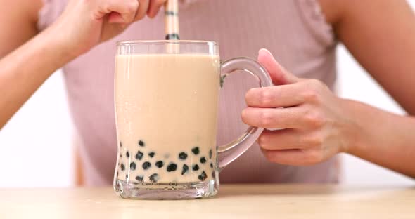 Woman enjoy Glass of Taiwan Bubble milk tea