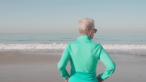 Senior Woman Exercising At The  Beach