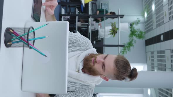 Vertical Screen Hipster Businessman Using Laptop and Tablet in Office