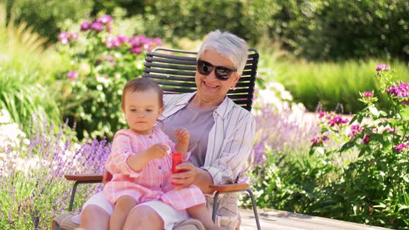 Happy Grandmother and Baby Granddaughter at Garden