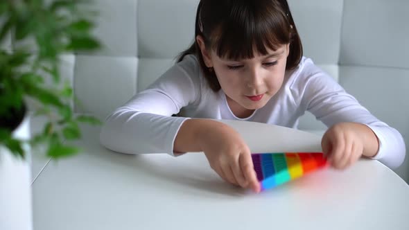 Baby Girl Playing with Rainbow Pop It Fidget