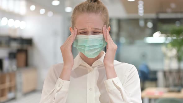 Portrait of Young Businesswoman with Face Mask Having Headache