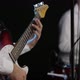 The Guitar Player Is Very Active on Stage with His Rock Band. Close-up - VideoHive Item for Sale