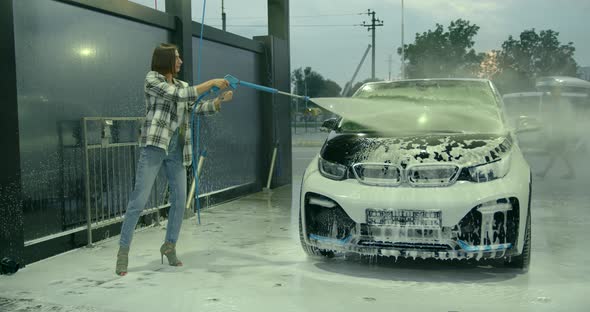 Beautiful Woman Washes the Car at the Car Wash