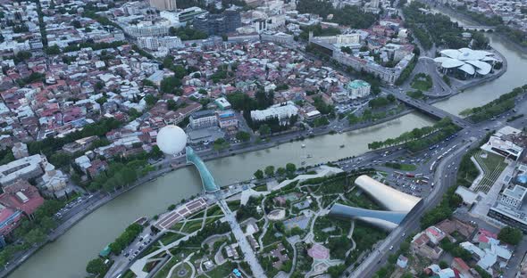 Aerial view of Tbilisi city central park and Bridge of Peace. Beautiful cityscape of old Tbilisi at