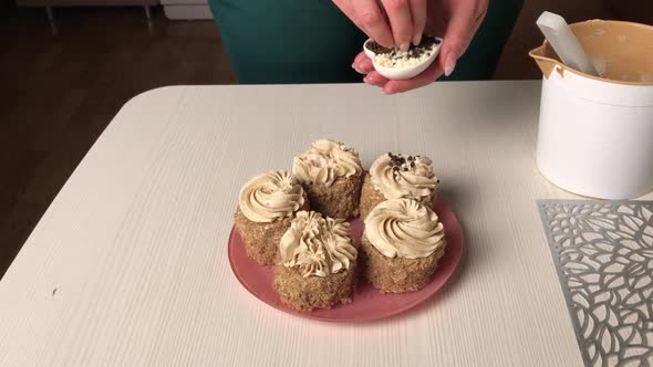 A Woman Makes A Sponge Cake With Butter Cream And Biscuit Crumbs