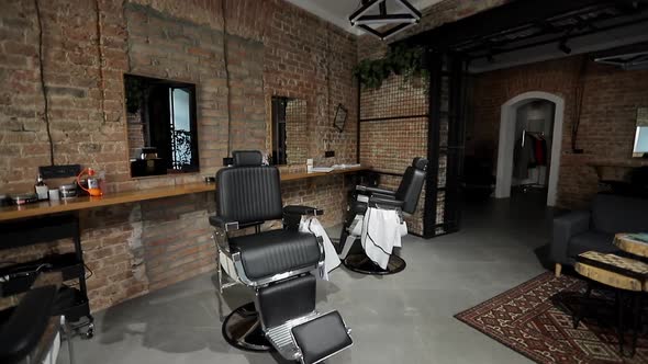 Interior of a Barber Shop with a Beautiful Design. Modern Chair with Levers in Hair Salon.