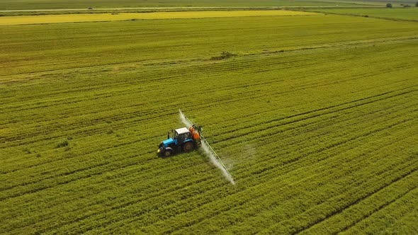 Tractor is Spraying Fertilizers Field