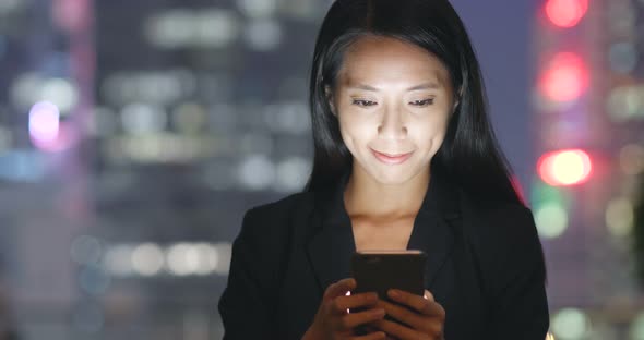 Businesswoman use cellphone at night