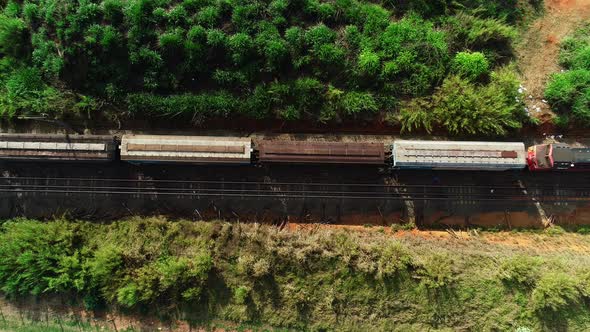 Aerial video of a freight train crossing the field, campinas, São Paulo, Brazil