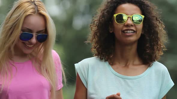 Two Female Friends Having Small Chat at Party, Smiling, Making Dance Movements