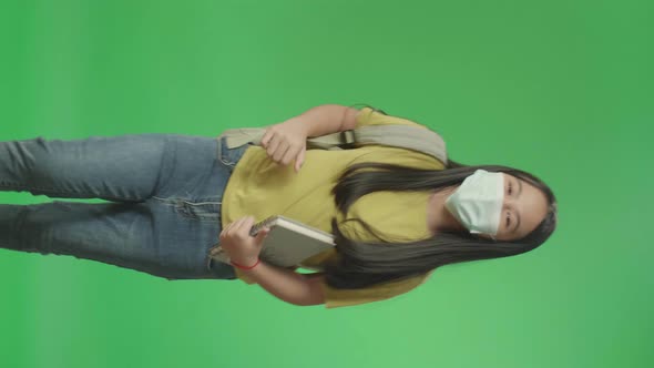 Asian Girl Student Wearing A Mask, Holding Book While Running To School On Green Screen