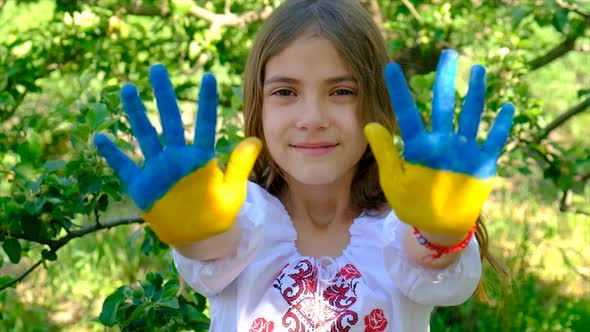 The Ukrainian Flag is Drawn on the Child Hands