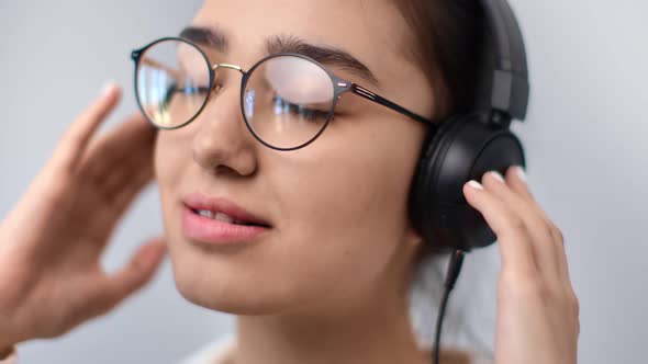 Extreme Closeup Mixed Race Young Girl Listening Music in Headphones Isolated