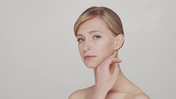 Studio portrait of young, beautiful and natural blond woman.