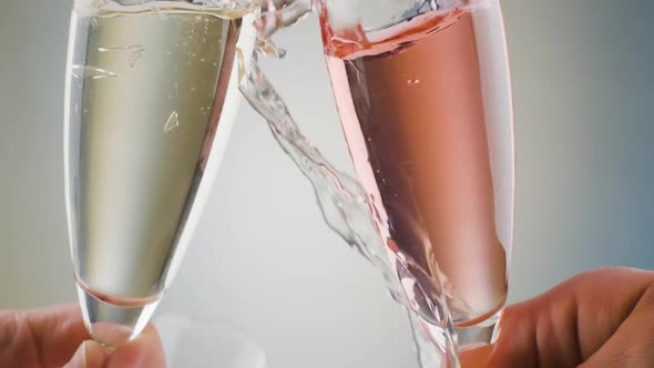 Close up  Champagne flutes smashing and breaking, White and pink Liquid, Slow motion