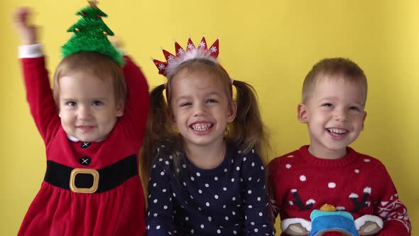 Emotion Cute Happy Cheerful 3 Siblings Friends Baby Girl And Boy in Santa Suit Smiling Laughing