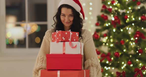 Funny Christmas Santa Woman With Gifts at Home