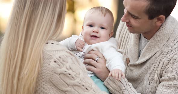 Parents Playing with Daughter, Kissing Child and Laughing